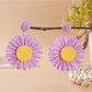 Vintage sunflower earrings styled with casual summer outfit on a model