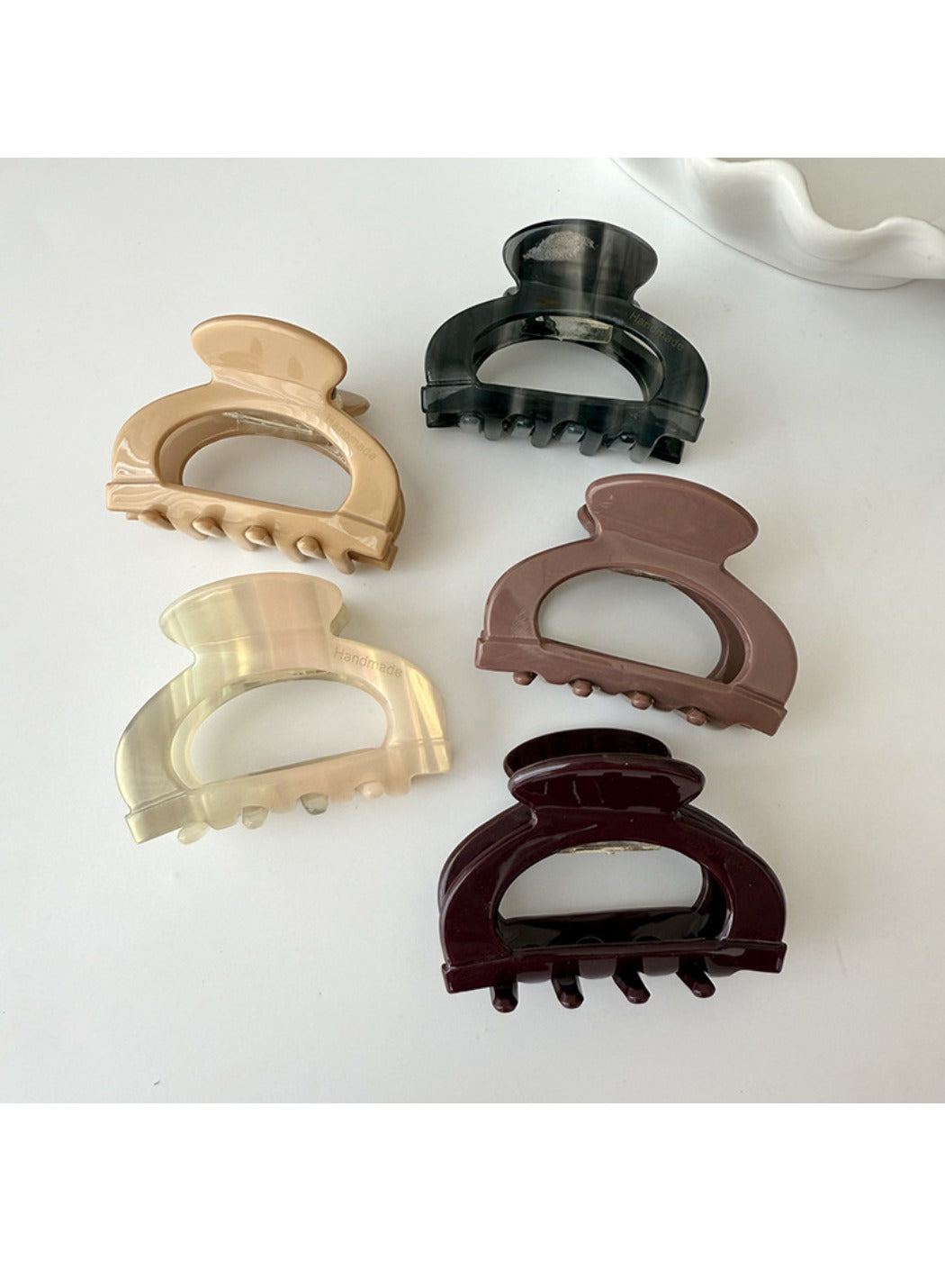 Close-up of Beau claw clip showing detailed openwork pattern and curved shape