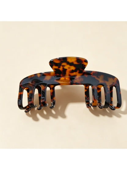 Beau claw clip styled in hair, securing medium-length brown hair