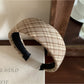 Wide plaid headband displayed on a mannequin head with neutral background