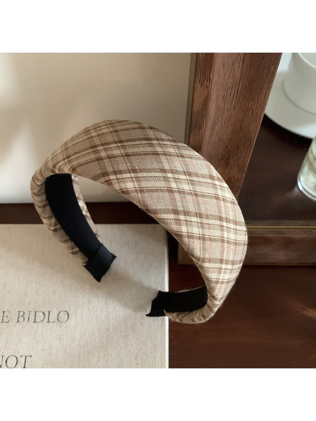 Wide plaid headband displayed on a mannequin head with neutral background