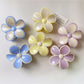 Beau color block flower shaped claw clip in pastel pink and cream on white background