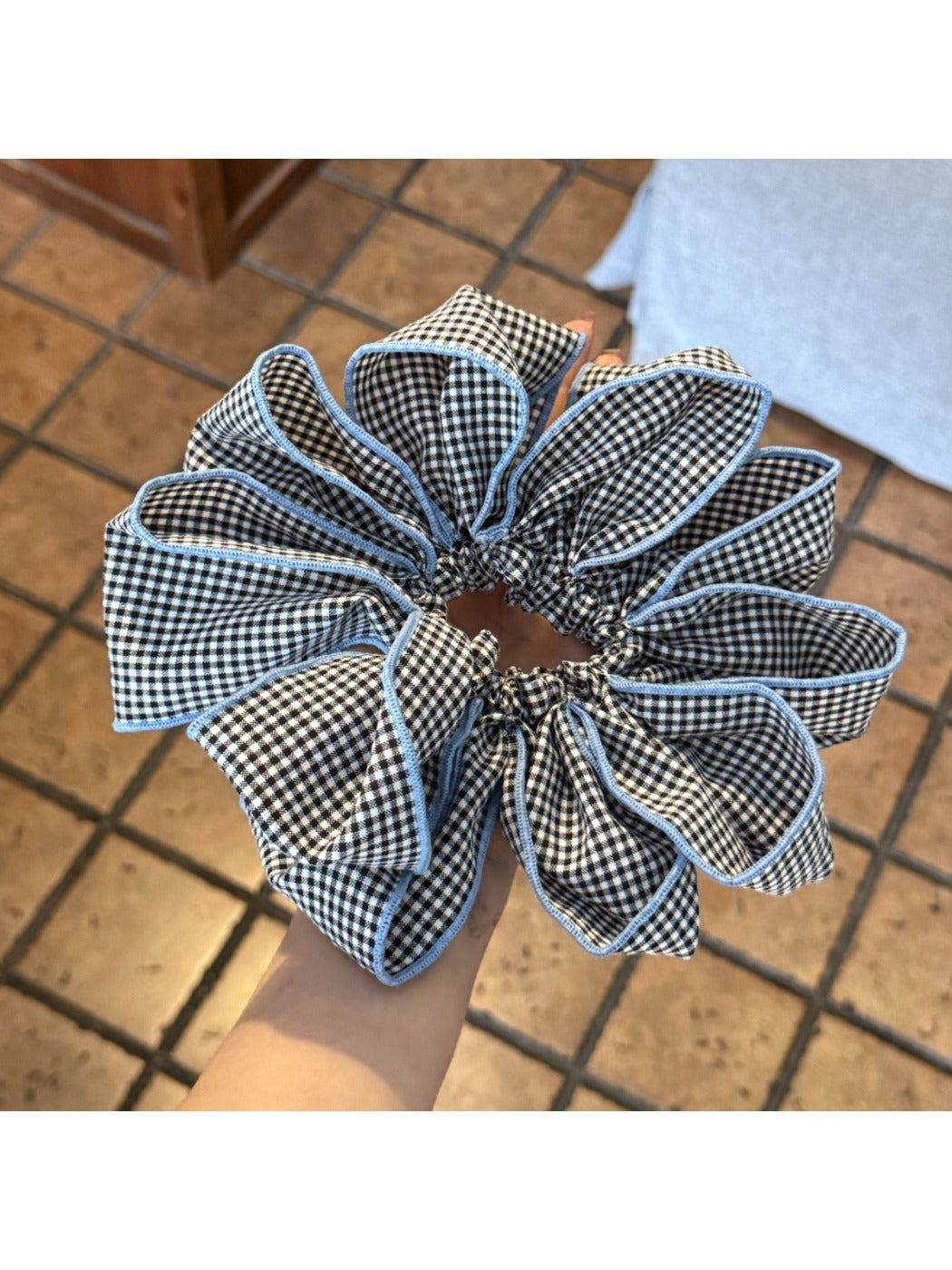 Flat lay of Gifty checked pattern scrunchie on white background