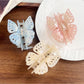 Beau butterfly hair claw clip held in hand to show size and lightweight design