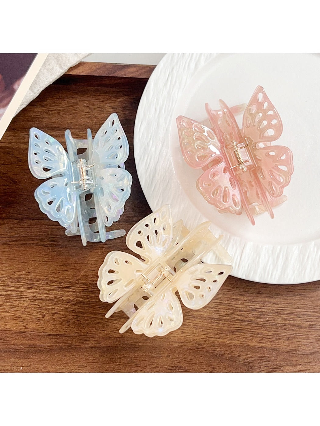 Beau butterfly hair claw clip held in hand to show size and lightweight design