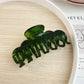 Beau claw clip in natural light highlighting glossy finish and color