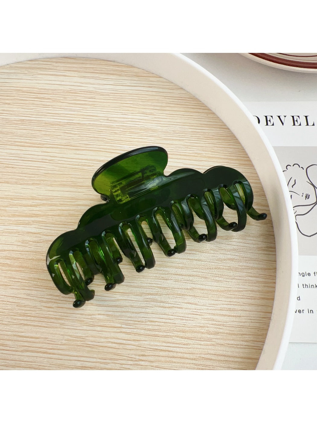 Beau claw clip in natural light highlighting glossy finish and color