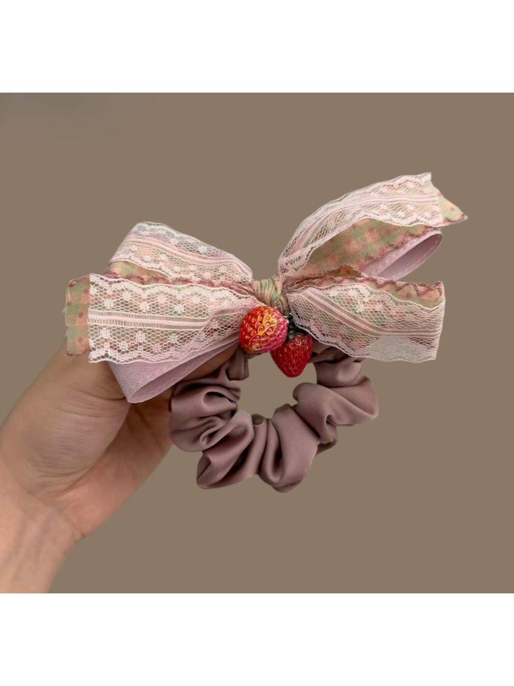 Model wearing Gifty Strawberry Charm Lace Bow Scrunchie in hair with visible red strawberry charm and lace bow