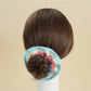 Top view of the scrunchie displaying its circular shape and fabric folds
