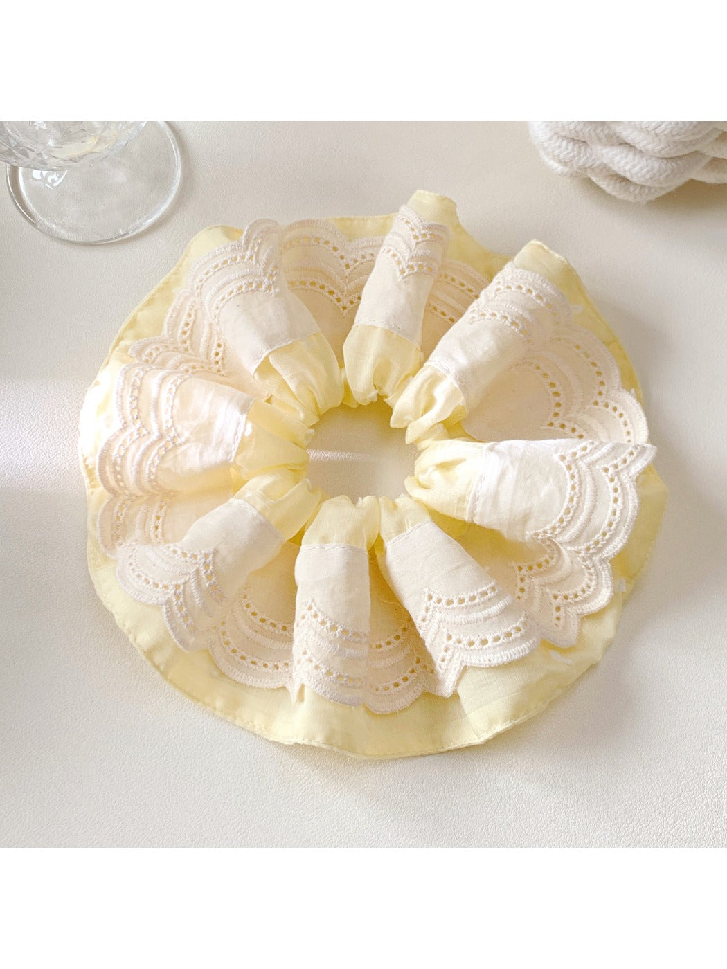 Gifty color block scrunchie in beige and brown tones against a soft pastel background