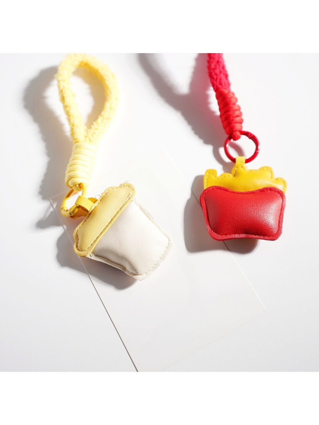 Close-up of Keypus keychain showing detailed fries and coffee cup charm