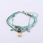 Lovra small bead alloy bracelet coiled to show flexibility and bead arrangement