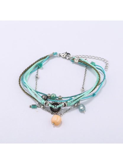 Lovra small bead alloy bracelet coiled to show flexibility and bead arrangement
