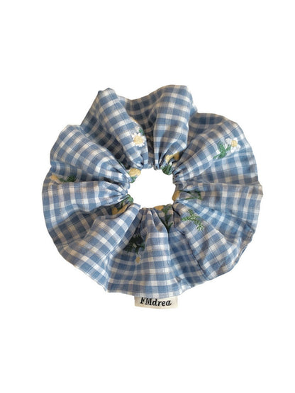 Blue plaid scrunchie displayed on a white background showing full shape