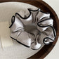 Ruffled satin scrunchie stretched slightly to show elasticity and fabric texture