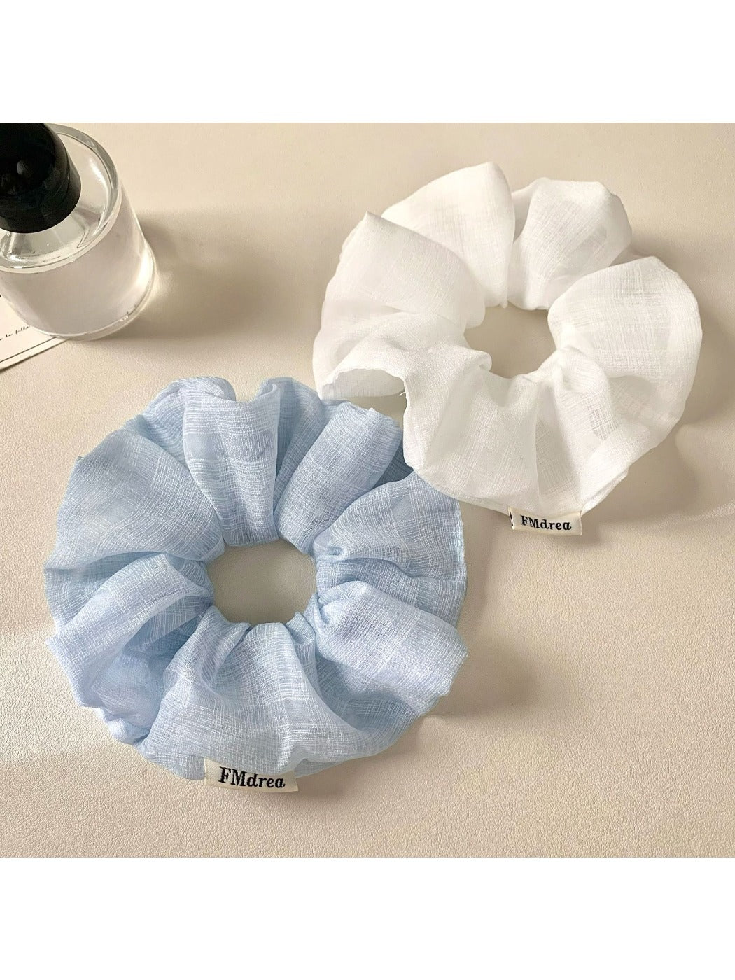 Close-up of a minimalist solid color ruched scrunchie on a white background