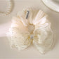 Close-up of pink tulle fabric and bow detail on scrunchie