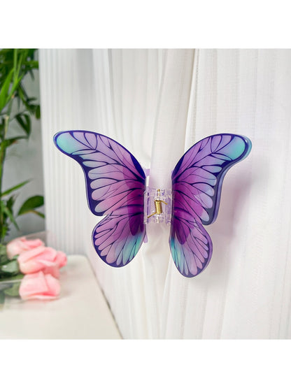 Beau butterfly hair claw clip held in hand to show size and shape