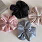 Gifty satin scrunchie with rhinestone decoration displayed on a white background