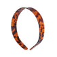 Top view of leopard print headband highlighting the twisted knot design