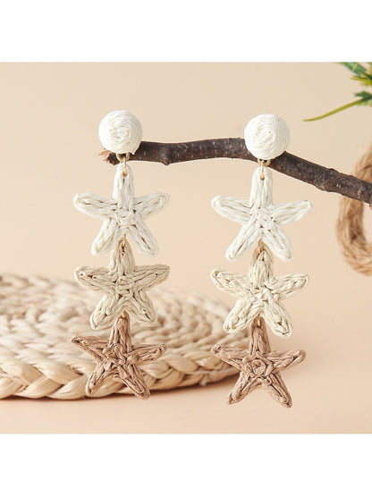 Earedge star pendant earrings worn on a model's ear