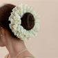 Gifty ruched scrunchie worn on a wrist as a stylish accessory