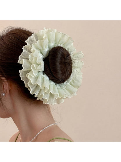 Gifty ruched scrunchie worn on a wrist as a stylish accessory