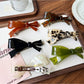 Beau acetate bow-shaped hair clip on white background showing front view