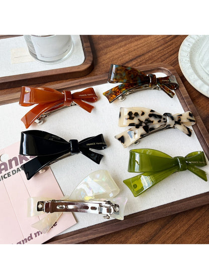 Beau acetate bow-shaped hair clip on white background showing front view