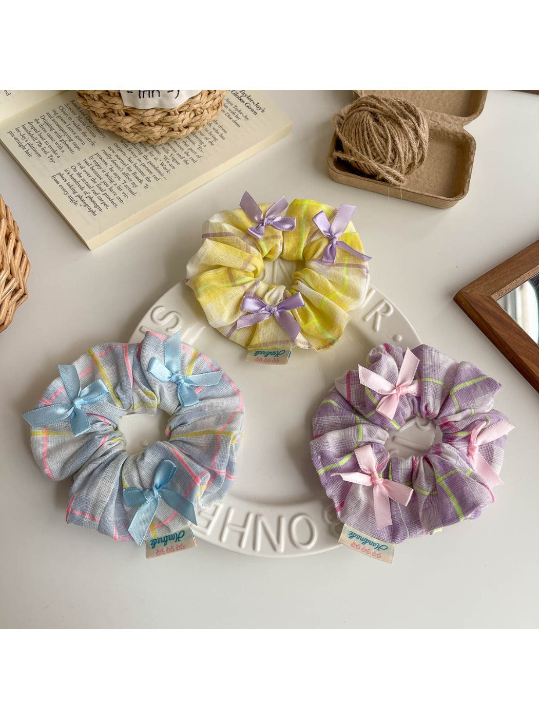 Side view of Gifty Ribbon Bow Plaid Scrunchie highlighting the bow and elastic band