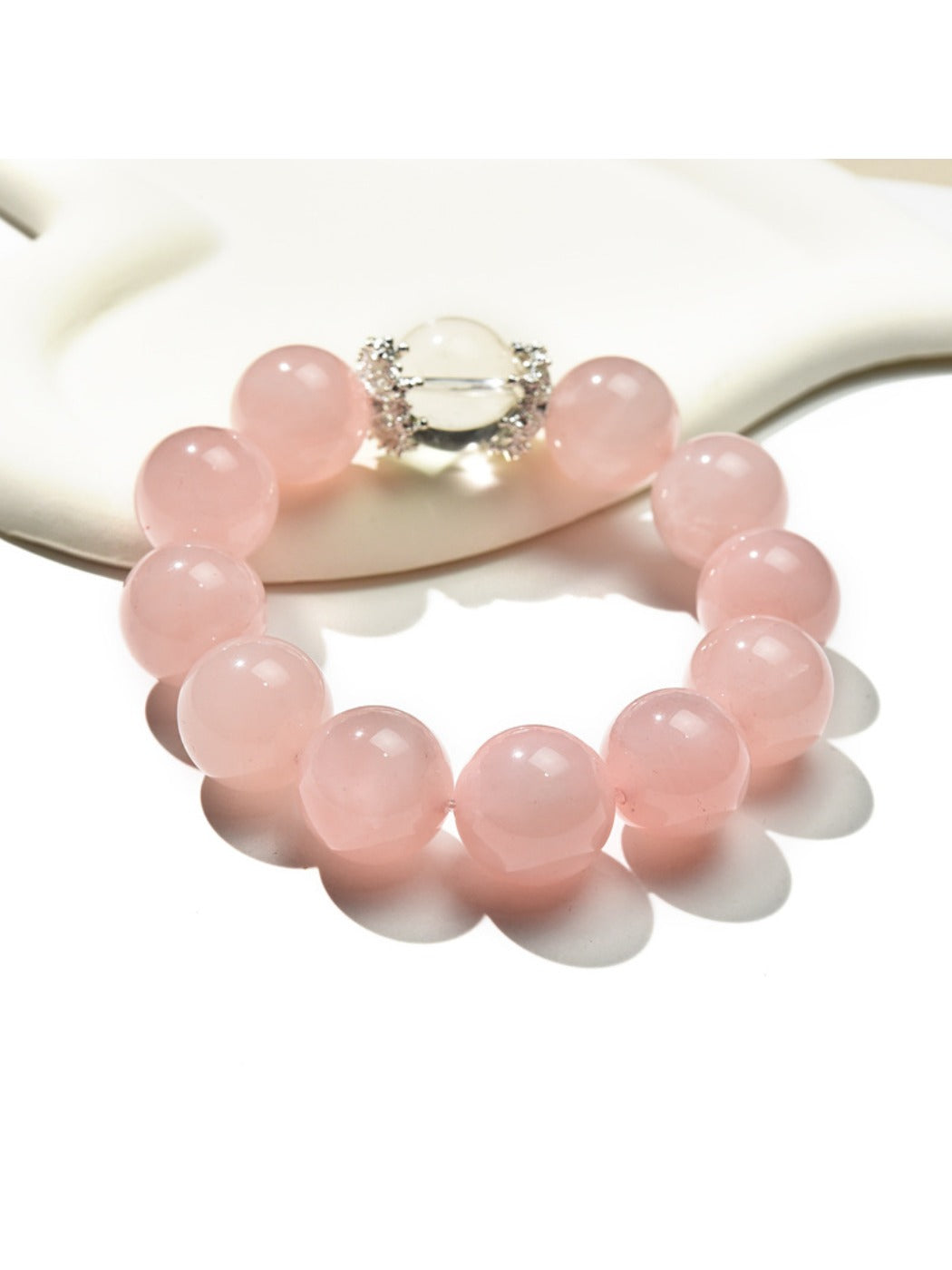 Lovra pink beaded crystal bracelet displayed flat showing round pink beads and silver accents