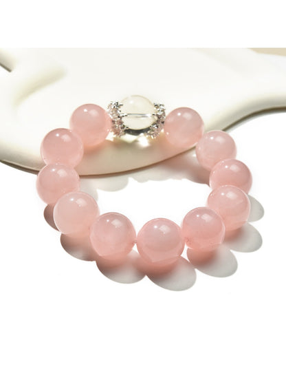 Lovra pink beaded crystal bracelet displayed flat showing round pink beads and silver accents