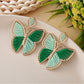 Close-up of the earring clasp and butterfly design in polished silver