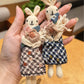 Close-up of the rabbit keychain showing detailed stitching and soft fabric texture