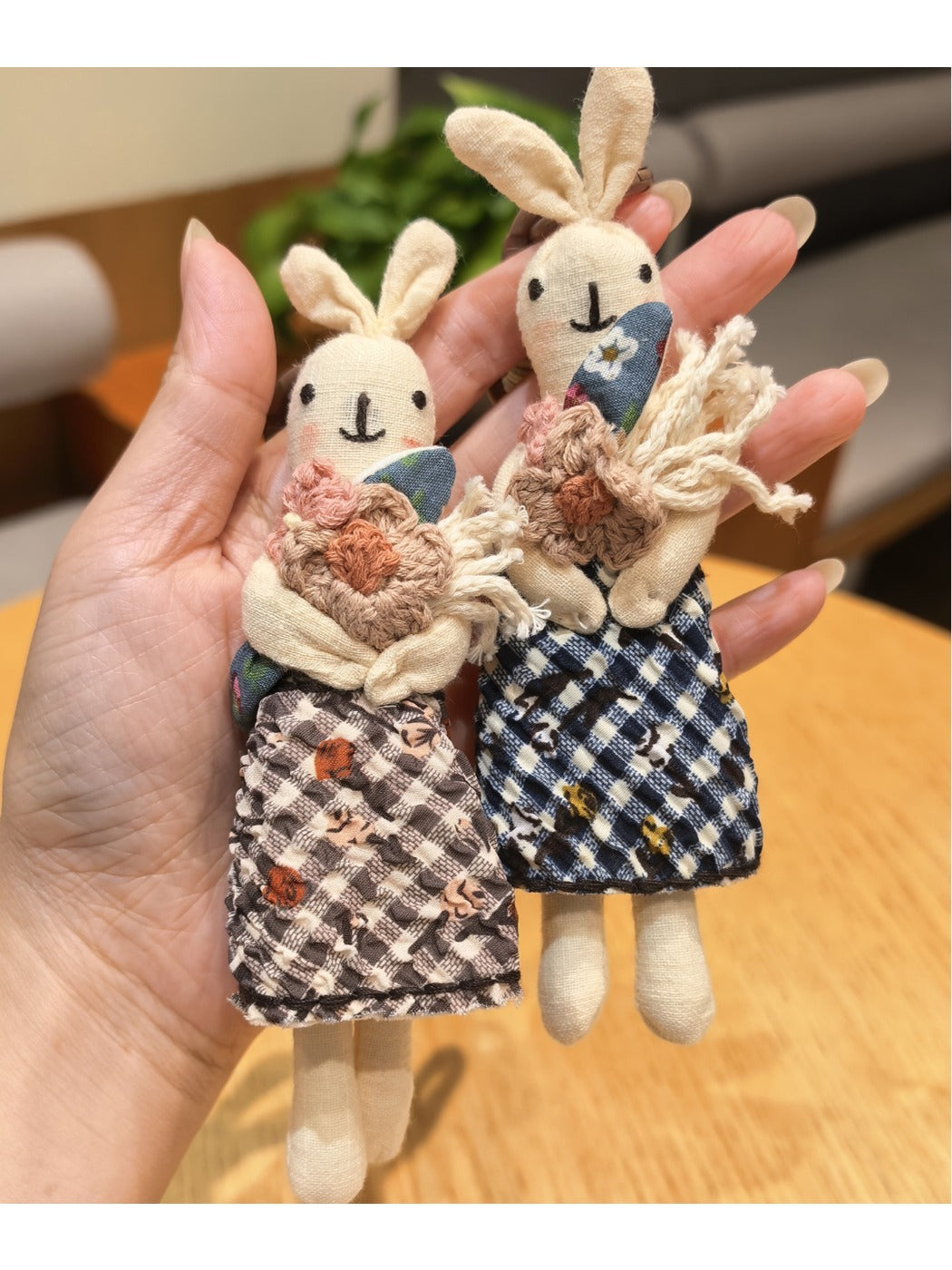 Close-up of the rabbit keychain showing detailed stitching and soft fabric texture