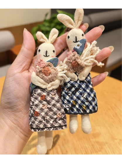 Close-up of the rabbit keychain showing detailed stitching and soft fabric texture