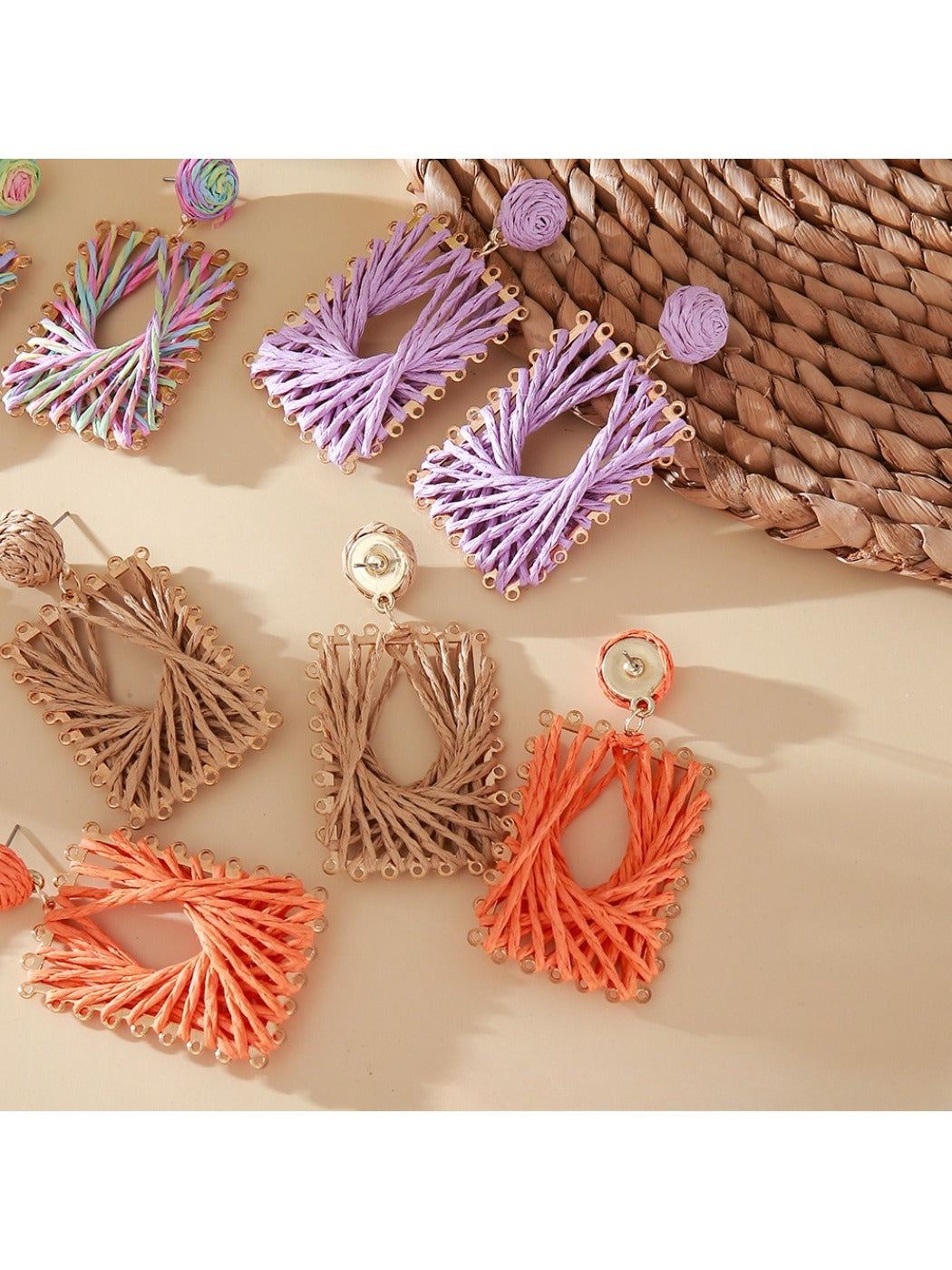 Earedge square earrings with raffia wrapping displayed on a wooden surface