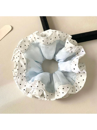 Gifty scrunchie worn on wrist as a fashion accessory with polka dot and color block design
