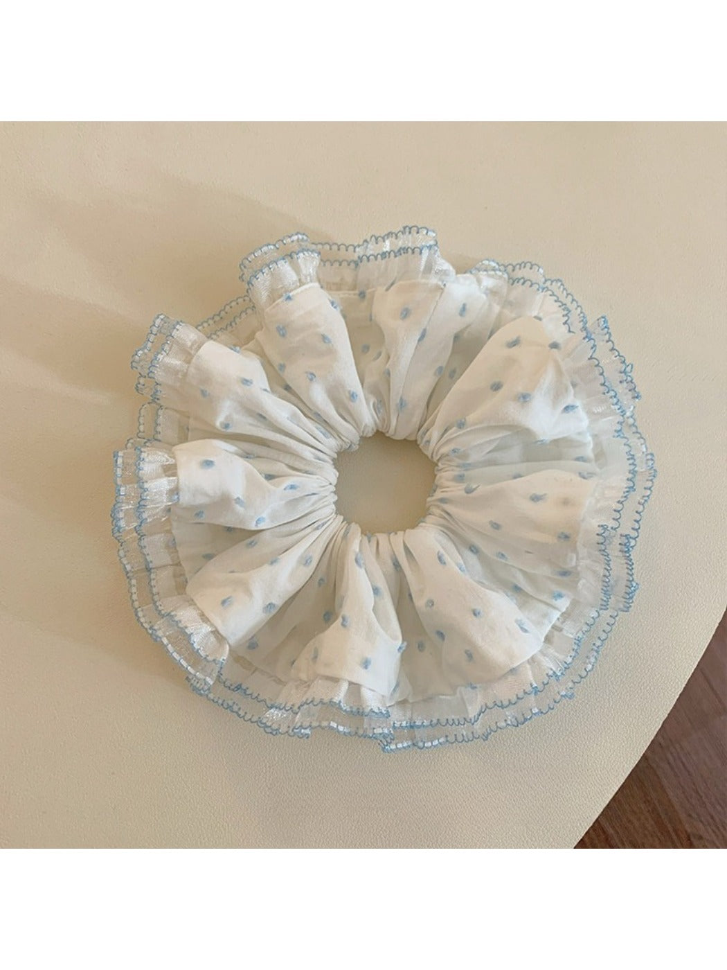 Chic black scrunchie with white polka dots and ruffled fabric detail