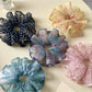 Gifty floral scrunchie displayed on a white background showing fabric texture