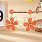 Earedge flower shaped drop earrings shown from multiple angles on a neutral background