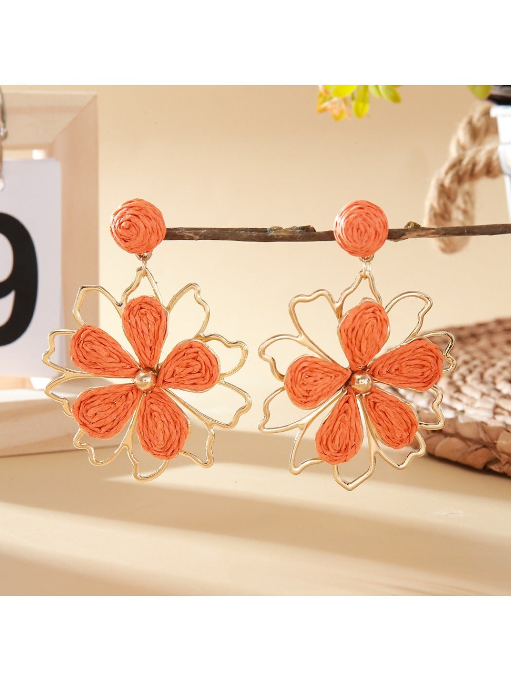 Earedge flower shaped drop earrings shown from multiple angles on a neutral background