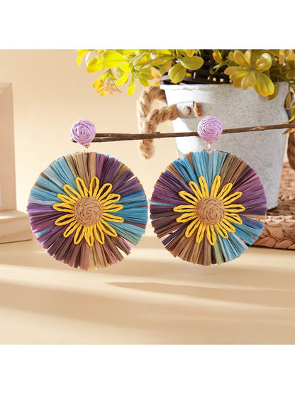 Earedge sunflower earrings displayed on a wooden surface with natural lighting