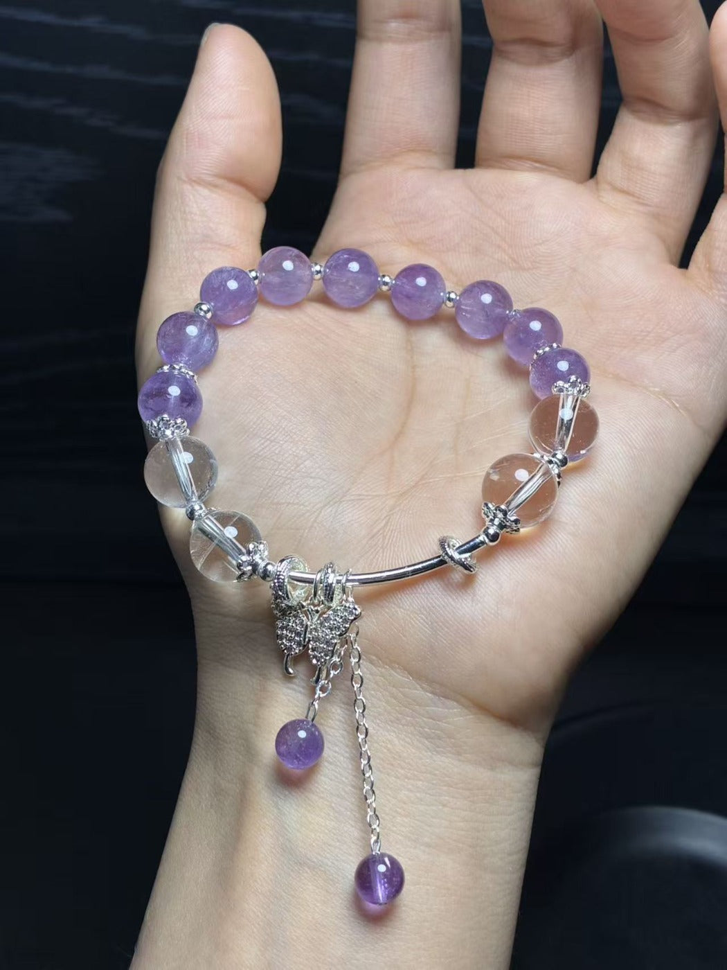 Lovra bracelet with butterfly charm and lavender crystal beads on a silver chain