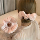 Satin scrunchie in a solid color displayed on a white background