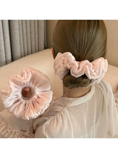 Satin scrunchie in a solid color displayed on a white background