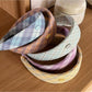 Side view of Gifty patterned headband highlighting elastic band and vibrant colors