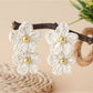 Top view of raffia flower earrings highlighting intricate woven pattern