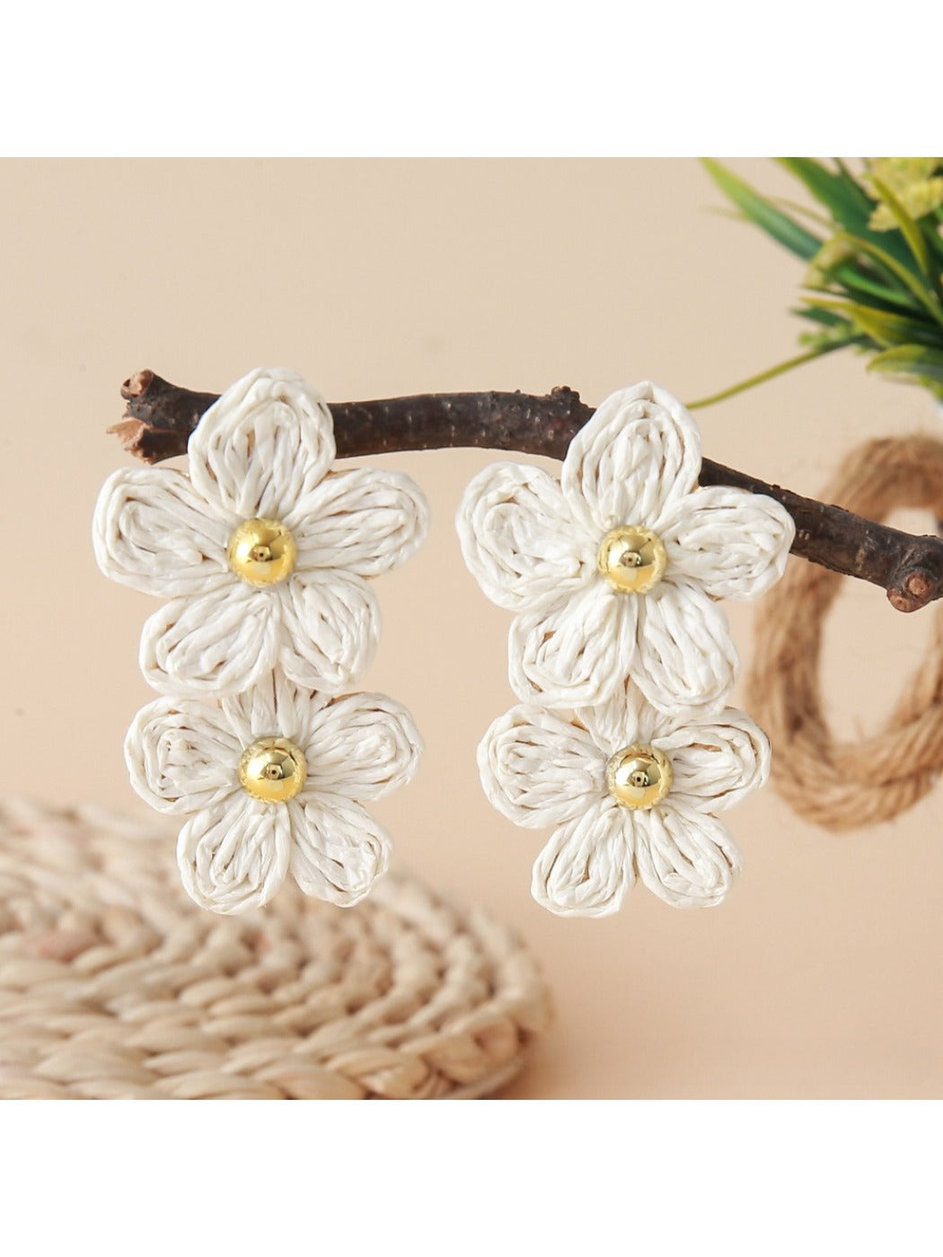 Top view of raffia flower earrings highlighting intricate woven pattern