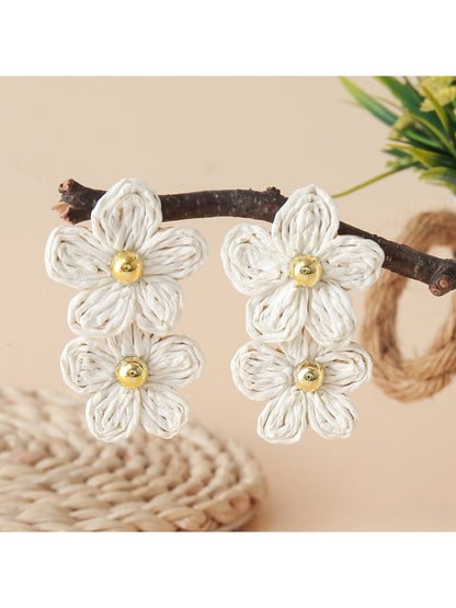 Top view of raffia flower earrings highlighting intricate woven pattern